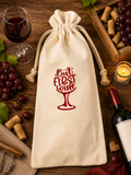 Custom Canvas Wine Bag-("But First Wine") with red lettering and a red wine glass graphic—perfect for gifting. Size: 5.9" x 13.7".
