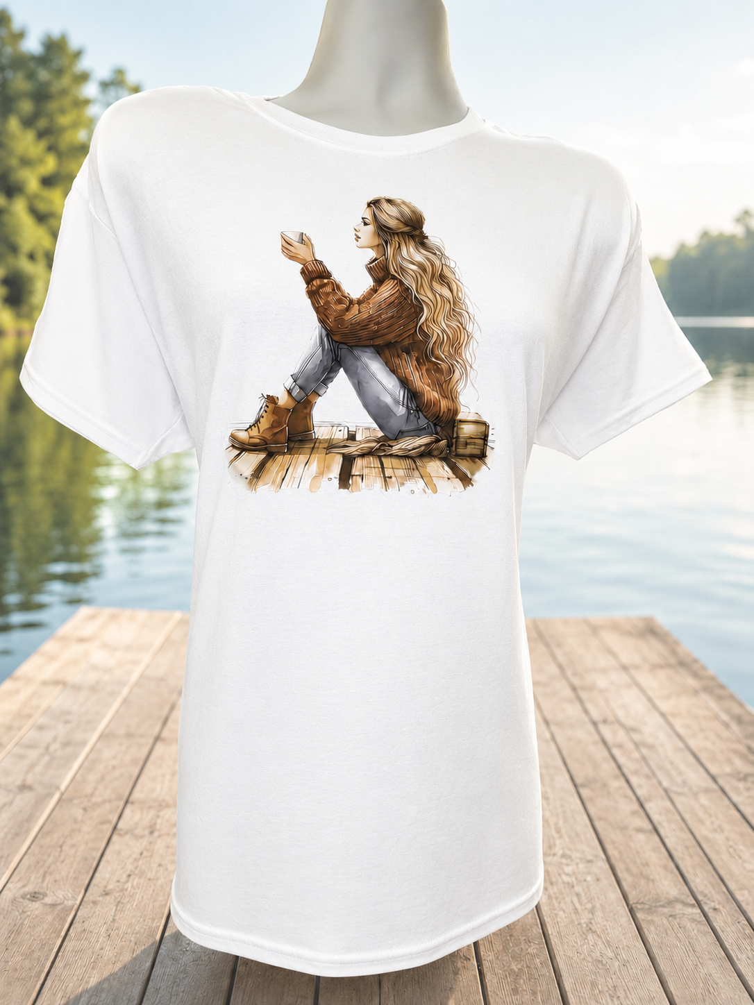 Custom Graphic T-Shirt- on a blonde woman wearing a brown sweater at the dock.