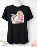 Custom Graphic T-Shirt- featuring a design of a girl in a pink sweater on a pier, deep in thought while drinking a cup of coffee.